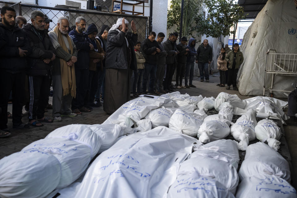 Palestinians mourn their relatives killed in the Israeli bombardment of the Gaza Strip, outside a morgue in Rafah, southern Gaza, Thursday, Jan. 18, 2024. (AP Photo/Fatima Shbair)