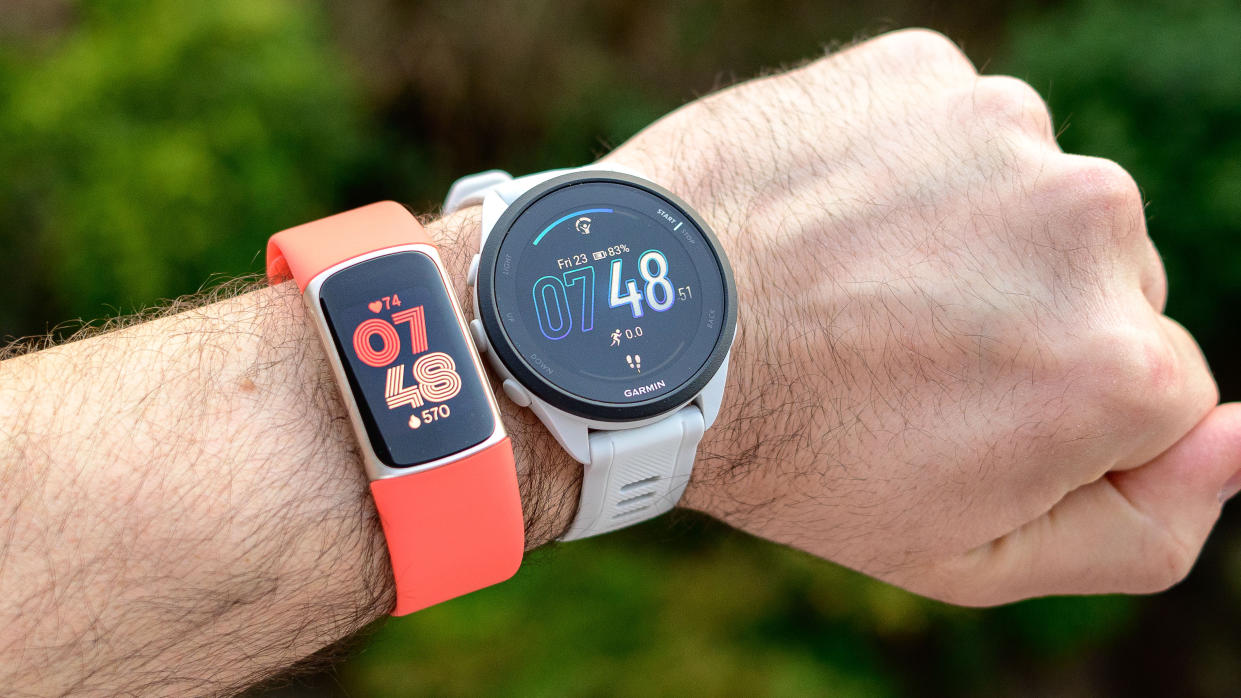  Fitbit Charge 6 and Garmin Forerunner 165 worn on the same wrist. . 