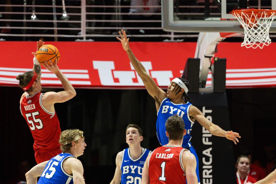 Utah Utes guard Gabe Madsen (55) shoots the ball with Brigham Young Cougars guard Trey Stewart (1) jumping to try and block during a men’s basketball game at the Jon M. Huntsman Center in Salt Lake City on Saturday, Dec. 9, 2023. | Megan Nielsen, Deseret News