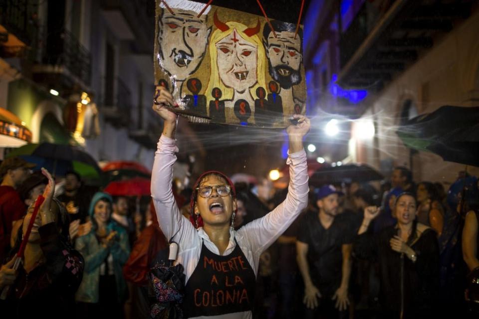 Protestors demand the resignation of Puerto Ricos Governor Wanda Vázquez Garced (center in the sign) and Senate President Thomas Rivera Shatz (left on the sign) during new protests in front of the governor’s mansion on January 23, 2020 in San Juan, Puerto Rico. (Photo by Jose Jimenez/Getty Images)