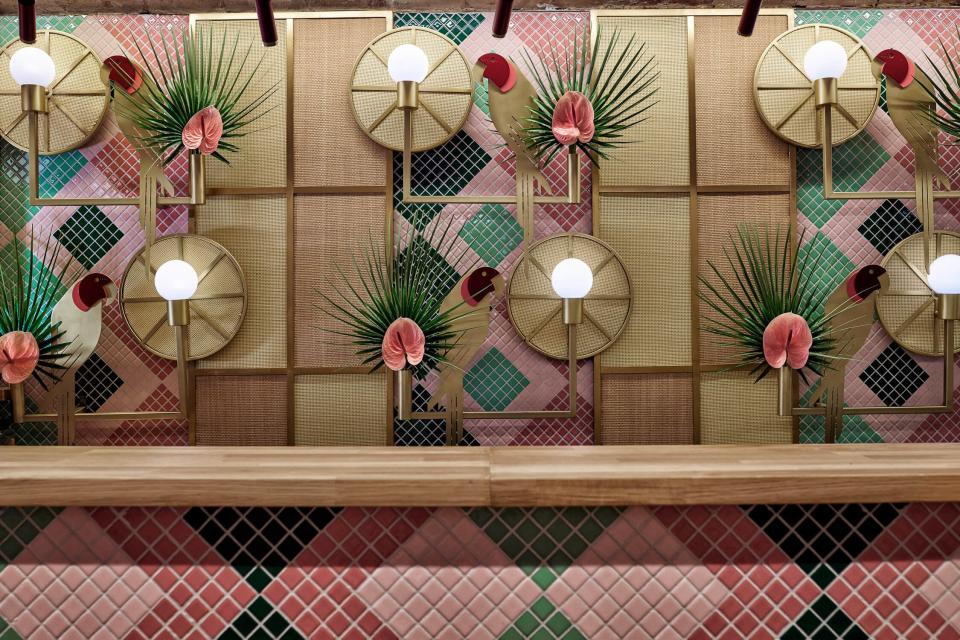 We love how the brass parrots—shockingly enough—blend right into the background, becoming another cohesive pattern at the busy bar.