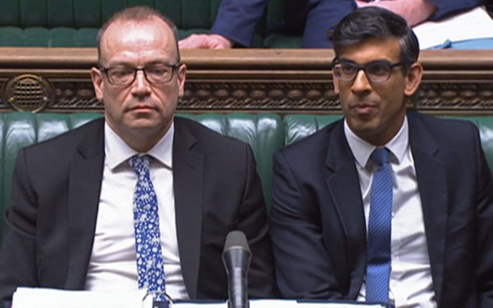 Chris Heaton-Harris, the Northern Ireland Secretary, and Rishi Sunak, the Prime Minister, are pictured in the House of Commons this afternoon - Getty Images