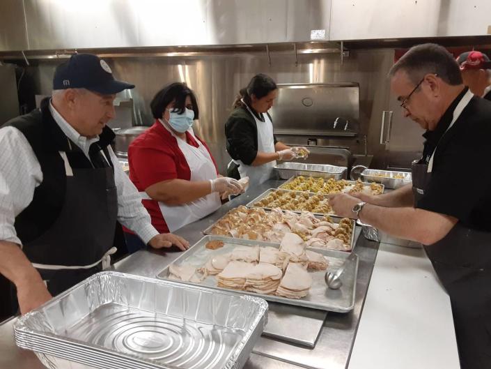 Dan Costa watches Wednesday, Nov. 23, 2022, as volunteers at Modesto Centre Plaza prepare part of the Thanksgiving meal.