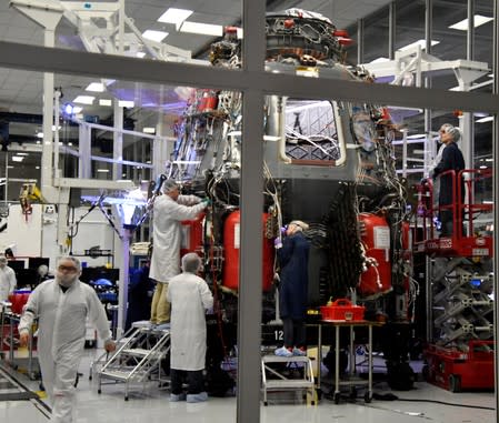 SpaceX technicians work on the next Crew Dragon Demo-2 craft as NASA Administrator Jim Bridenstine tour SpaceX headquarters with NASA astronauts Bob Behnken and Doug Hurley in Hawthorne