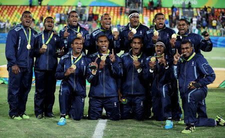 2016 Rio Olympics - Rugby - Men's Victory Ceremony - Deodoro Stadium - Rio de Janeiro, Brazil - 11/08/2016. Team Fiji pose for photos with their gold medals. REUTERS/Phil Noble