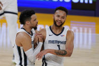 Memphis Grizzlies guard Dillon Brooks, left, and forward Kyle Anderson congratulate each other during a timeout in the first half of the team's NBA basketball game against the Los Angeles Lakers on Friday, Feb. 12, 2021, in Los Angeles. (AP Photo/Mark J. Terrill)