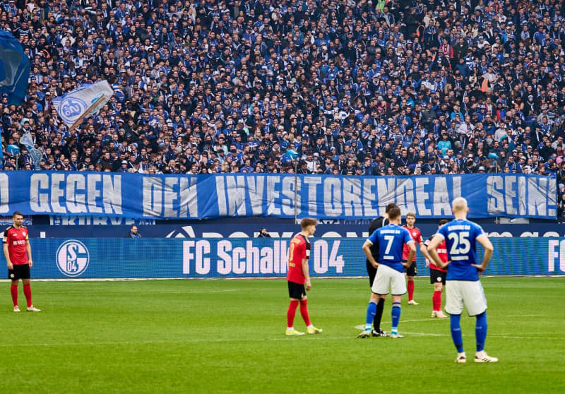 Schalke fans are seen in the stands during the German second Bundesliga soccer match between FC Schalke 04 and SV Wehen Wiesbaden at Veltins Arena. The nine German second division games on the last matchday have for the first time ever attracted more fans than the nine Bundesliga matches, Kicker sports magazine has reported. Bernd Thissen/dpa