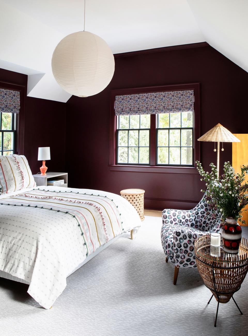 This guest room has a “tremendous presence,” observes Galli. The dark walls, painted in a Farrow & Ball hue, are purposefully paired with delicate, light furniture. The modern platform bed is from The Inside. The vintage armchair is from 1stDibs, and the bright rug is Kravet. The floor lamp is Celerie Kemble, and the window fabric is by Shyam Ahuja.