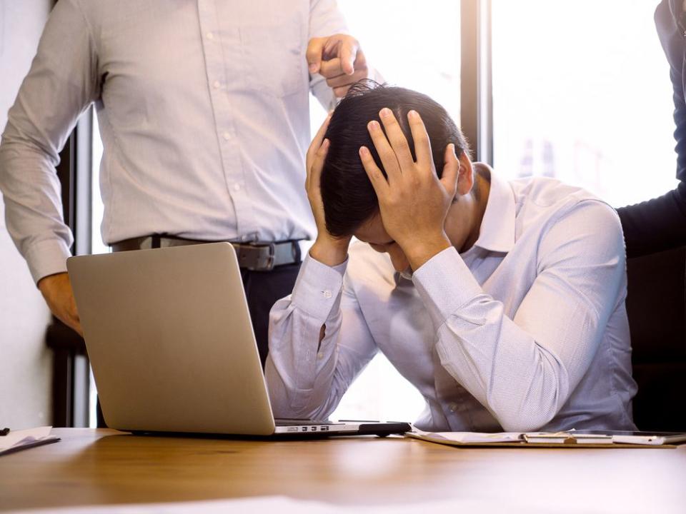 Business people blaming frustrated male colleague in Office. Negative human emotions concept