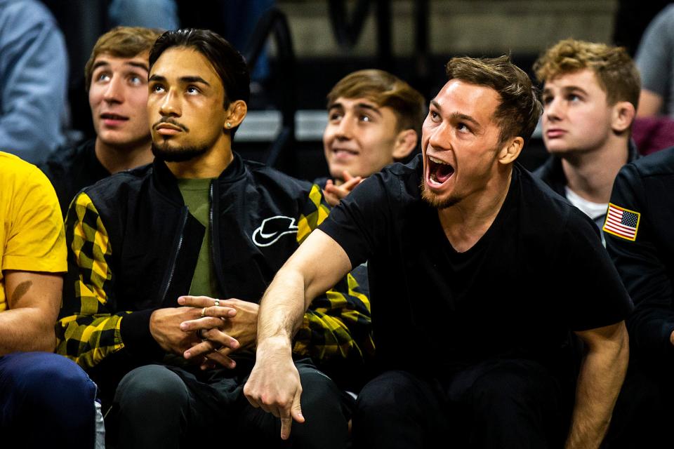 Iowa wrestlers Real Woods, left, and Spencer Lee watch during a NCAA men's wrestling dual against Penn, Saturday, Nov. 26, 2022, at Carver-Hawkeye Arena in Iowa City, Iowa.