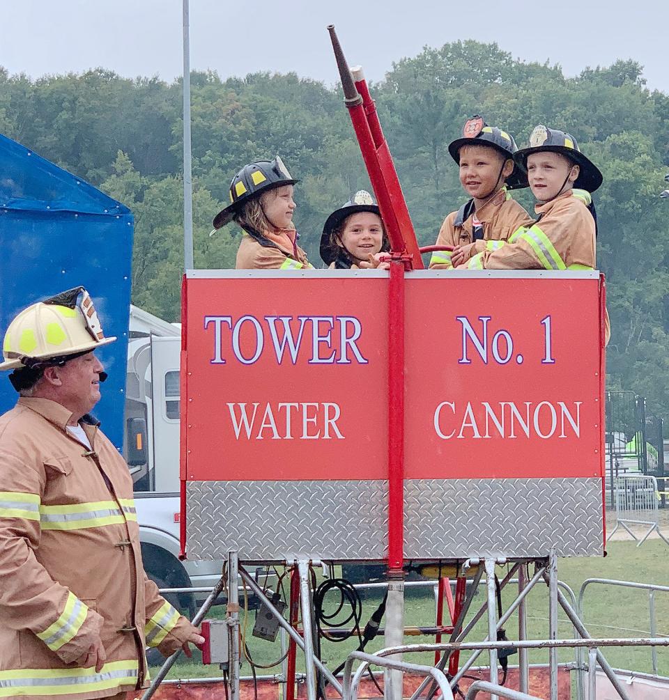 A group of young firefighters take part in a drill during a firefighter show for kids at the Emmet-Charlevoix County Fair in Petoskey in a previous year.