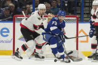 Tampa Bay Lightning left wing Conor Sheary (73) plays the puck in front of Ottawa Senators defenseman Artem Zub (2) during the first period of an NHL hockey game Thursday, April 11, 2024, in Tampa, Fla. (AP Photo/Chris O'Meara)