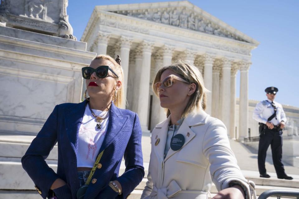 <div class="inline-image__caption"><p>Actors and activists Busy Philipps and Elizabeth Banks participate in an abortion rights rally outside of the Supreme Court as the justices hear oral arguments in the <em>June Medical Services v. Russo</em> case on March 4, 2020, in Washington, D.C. </p></div> <div class="inline-image__credit">Sarah Silbiger/Getty</div>