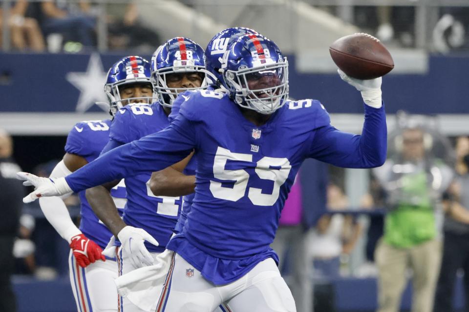 New York Giants linebacker Lorenzo Carter (59) celebrates intercepting a Dallas Cowboys' Dak Prescott pass in the first half of an NFL football game in Arlington, Texas, Sunday, Oct. 10, 2021. (AP Photo/Michael Ainsworth)