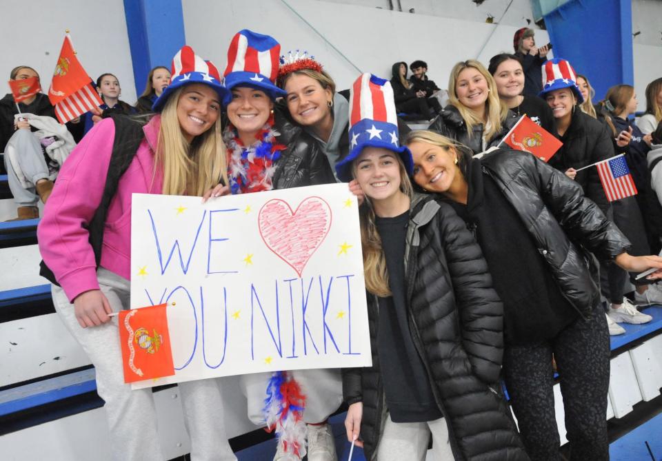 Braintree fans show their support for Wamps ice hockey player Nikki McNamee as she is honored for entering the Marine Corps prior to a game against Wellesley at the Zapustas Arena in Randolph, Wednesday, Jan. 31, 2024.