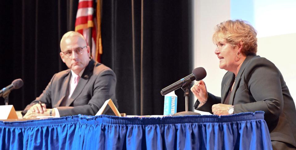 Candidate for sheriff, Democrat Donna Buckley, speaks as state Rep. Tim Whelan (R-Brewster) listens at the forum at Cape Cod Community College Wednesday evening.