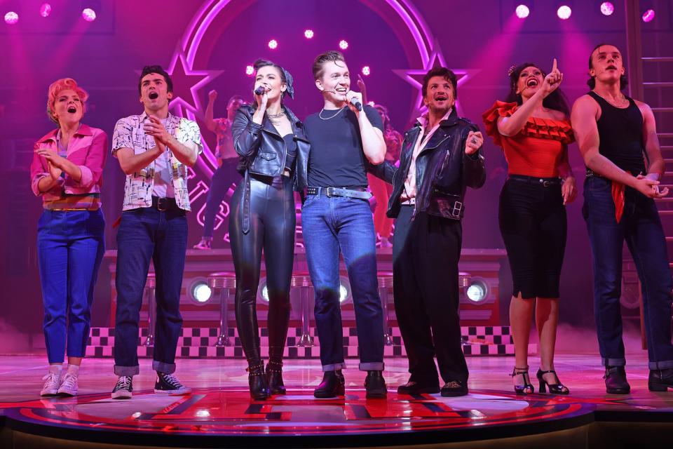 Eloise Davies, Damon Gould, Olivia Moore, Dan Partridge, Peter Andre, Jocasta Almgill and Paul French bow at the curtain call during the press night performance of "Grease The Musical" at the Dominion Theatre on May 17, 2022 in London, England.