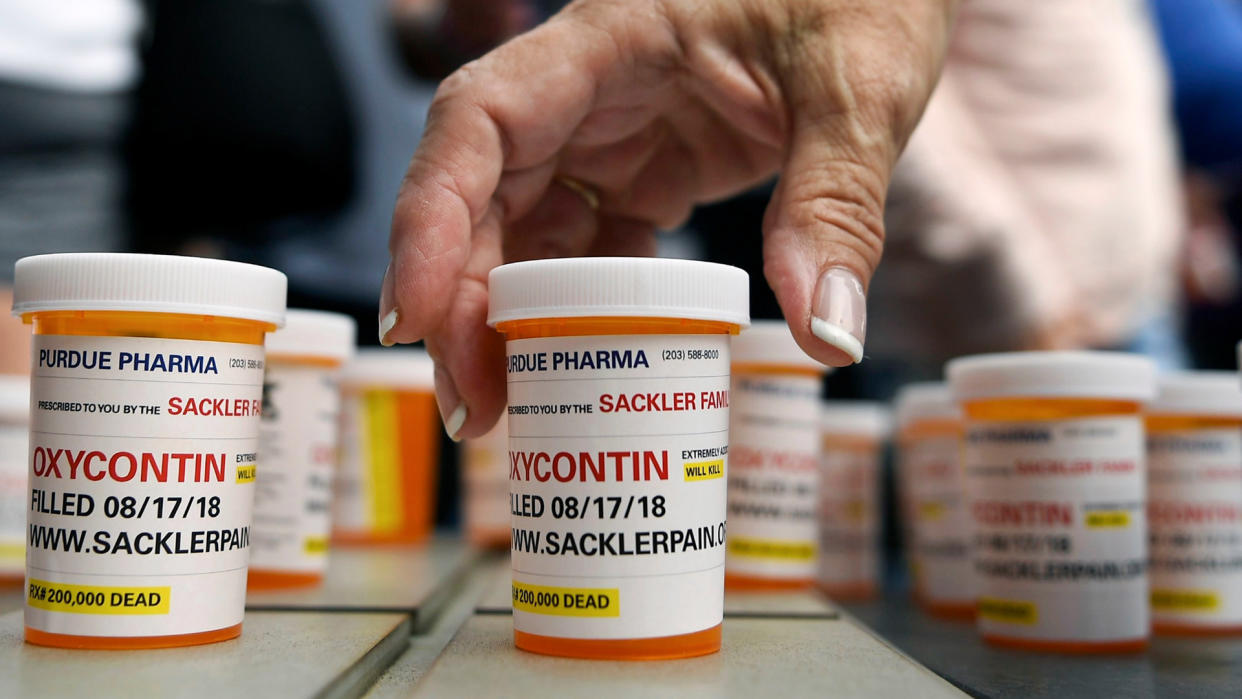 Photo by Jessica Hill/AP/REX/Shutterstock Family and friends who have lost loved ones to OxyContin and opioid overdoses leave pill bottles in protest outside the headquarters of Purdue Pharma, which is owned by the Sackler family, in Stamford, Conn. The Sackler family's ties to OxyContin and the painkiller's role in the deadly opioid crisis are bringing the Sacklers a new kind of attention and complicating their philanthropic legacy Opioid Crisis Philanthropy, Stamford, USA - 17 Aug 2018