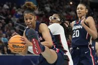 UConn's Evina Westbrook grabs a ball in front of Stanford's Francesca Belibi during the first half of a college basketball game in the semifinal round of the Women's Final Four NCAA tournament Friday, April 1, 2022, in Minneapolis. (AP Photo/Eric Gay)