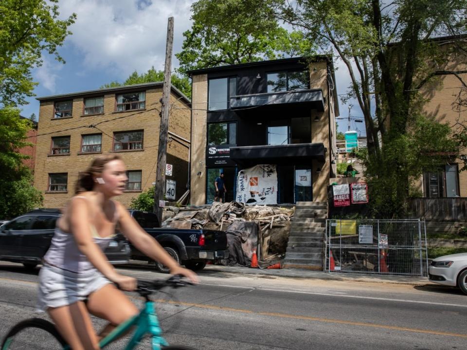 A multiplex project is seen (at centre) in Toronto's Regal Heights neighbourhood earlier this week. Building design and development experts say the multiplex form can give more people a home on the same parcels of land, while providing options for revamping properties accordingly. (Nav Rahi/CBC - image credit)