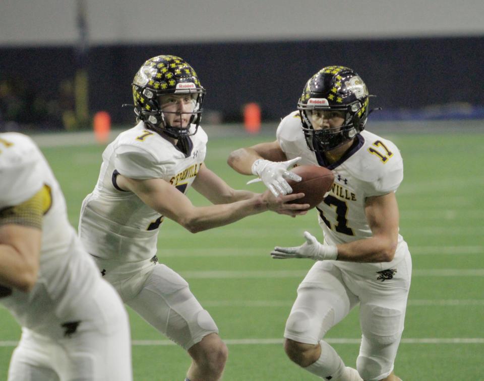 Stephenville quarterback Ryder Lambert (right) hands off to Tate Maruska against Hirschi in the 4A Division I state semifinals on Dec. 10, 2021.