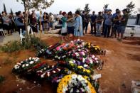 FILE PHOTO: Family and friends mourn around the fresh graves of Haya, Elad and Yossi, three members of the Salomon family who were killed in a stabbing attack in the Jewish settlement of Neve Tsuf, in the occupied West Bank, during their funeral in Modiin, Israel July 23, 2017 REUTERS/Ronen Zvulun/File Photo