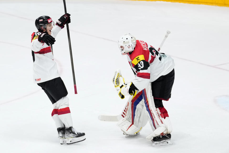 Austria's David Kickert, right, celebrates with Austria's Vinzenz Rohrer after the preliminary round match between Norway and Austria at the Ice Hockey World Championships in Prague, Czech Republic, Sunday, May 19, 2024. (AP Photo/Petr David Josek)