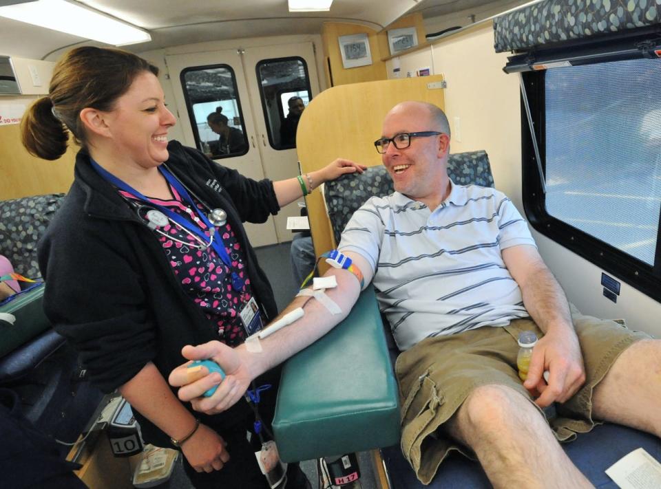 Boston Children's Hospital registered nurse Kerry Bickford shares a laugh with Dan Kelley, of Quincy, as he donates blood during the Boston Children's Hospital blood drive Friday, June 14, 2019.