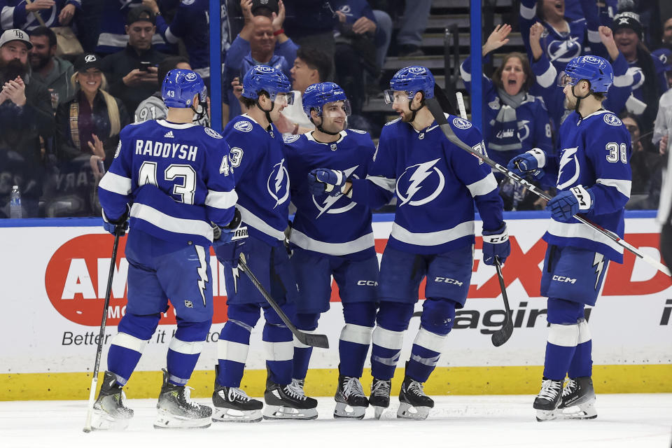Tampa Bay Lightning's Darren Raddysh, Michael Eyssimont, Conor Sheary, Anthony Cirelli and Brandon Hagel, from left, celebrate a goal against the Minnesota Wild during the third period of an NHL hockey game Thursday, Jan. 18, 2024, in Tampa, Fla. (AP Photo/Mike Carlson)