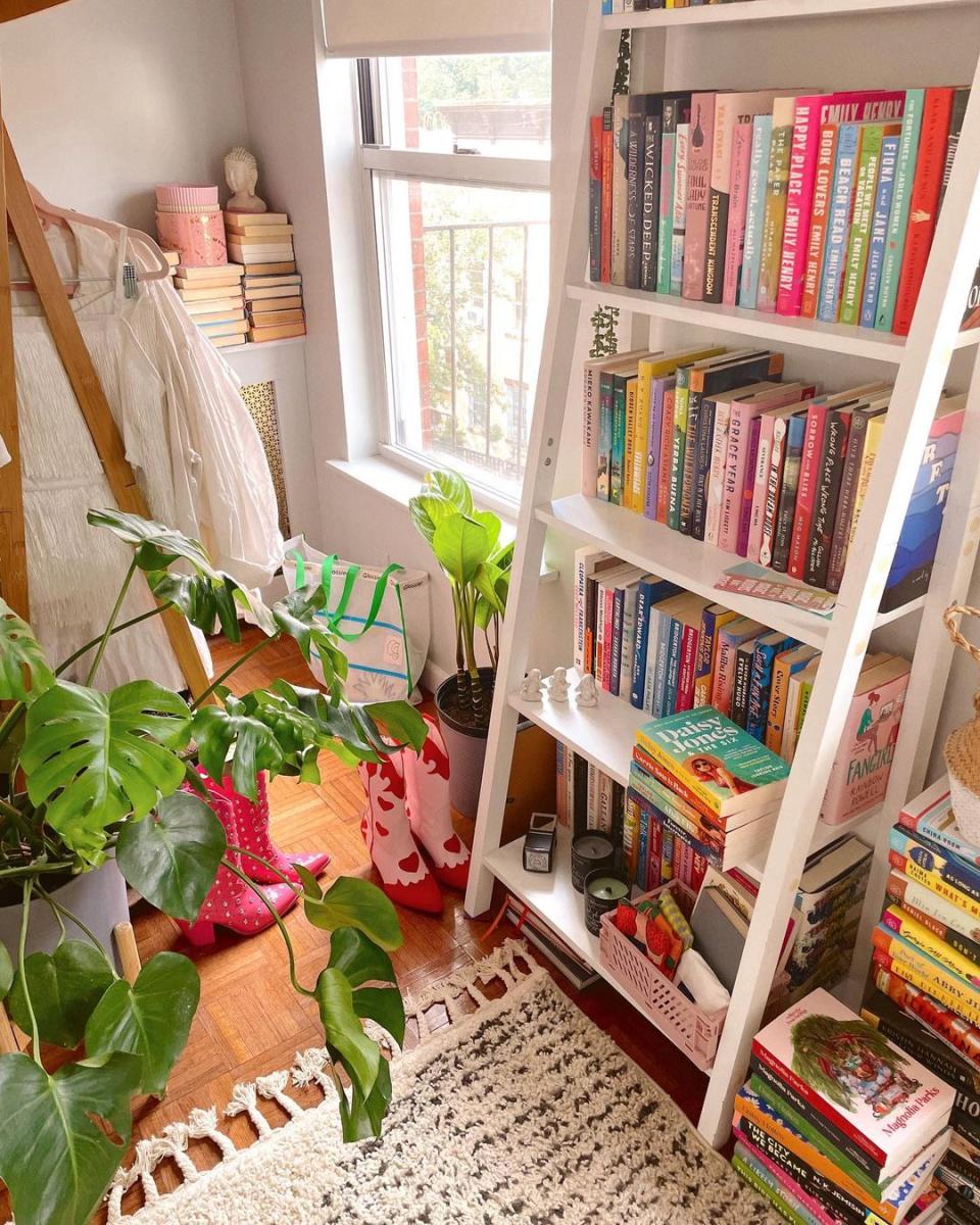 White leaning bookshelf and colorful books