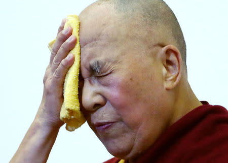 FILE PHOTO: Tibet's exiled spiritual leader the Dalai Lama wipes his face during an international conference of Tibet support groups in Brussels, Belgium, September 8, 2016. REUTERS/Yves Herman/File Photo