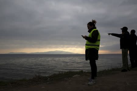 Volunteers wait for the arrival of a rubber dinghy packed with refugees and migrants on a beach on the Greek island of Lesbos, in this January 29, 2016 file photo. REUTERS/Darrin Zammit Lupi/Files