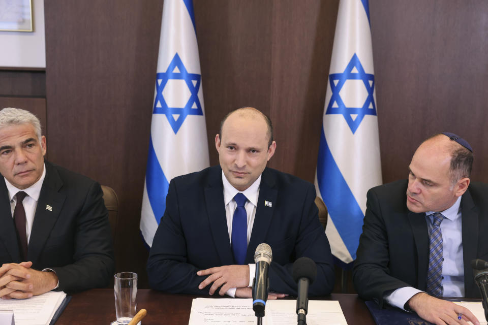 Israeli Prime Minister Naftali Bennett, center, chairs the first weekly cabinet meeting of the new government in Jerusalem, Sunday, June 20, 2021. Bennett opened his first Cabinet meeting on Sunday since swearing in his new coalition government last with a condemnation of the newly elected Iranian president, whom he called “the hangman of Tehran.” (Emmanuel Dunand/Pool Photo via AP)