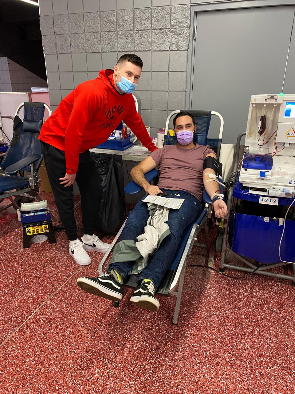 Ohio State's Kyle Young visits with blood donor Justin McMahon at the Jerome Schottenstein Center while participating in the annual blood battle between Ohio State and Michigan.