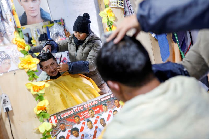 An artisanal gold miner has his hair cut at a hairdresser in La Rinconada, in the Andes