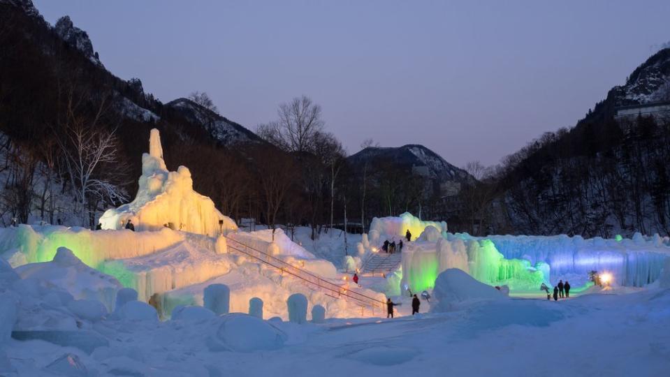 snowy town and sculptures lit up in a Japan snow festival 