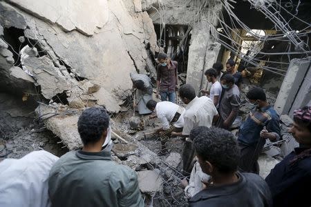 People search for survivors under the rubble of the collapsed house of Yemen's late prime minister Faraj Bin Ghanim after it was hit by a Saudi-led air strike in Sanaa July 2, 2015. REUTERS/Khaled Abdullah