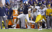 TCU wide receiver Quentin Johnston (1) stiff-arms West Virginia safety Sean Mahone (29) after making a catch for a first down during the first half of an NCAA college football game Saturday, Oct. 23, 2021, in Fort Worth, Texas. (AP Photo/Ron Jenkins)