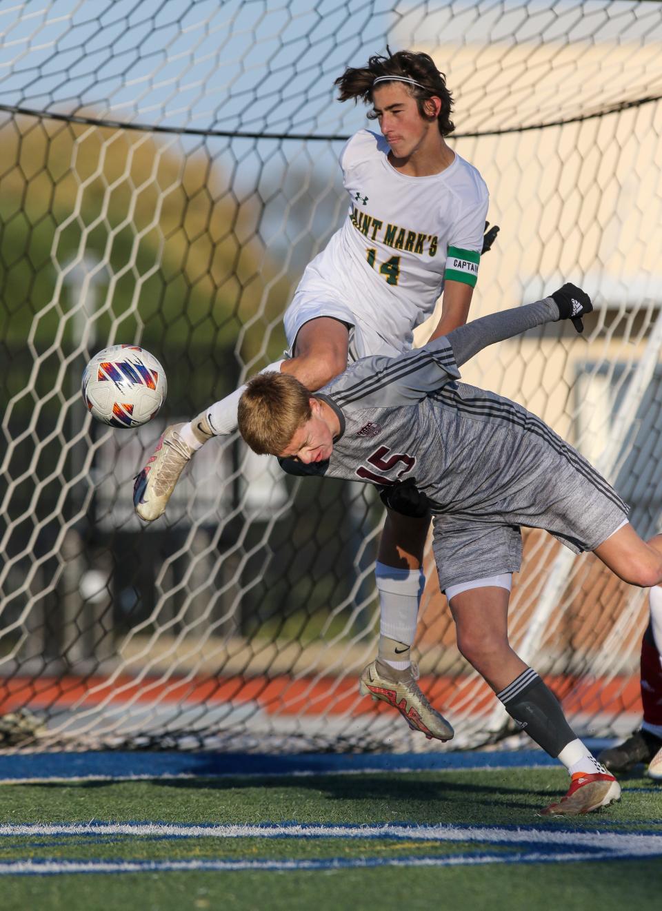 Caravel’s Finlay Lum (15) heads the ball away from the goal under Saint Mark’s midfielder Jonathan Lennon.