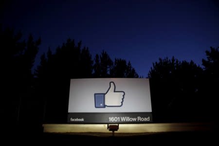 FILE PHOTO: The sun rises behind the entrance sign to Facebook headquarters in Menlo Park before the company's IPO launch, May 18, 2012.  REUTERS/Beck Diefenbach/File Photo