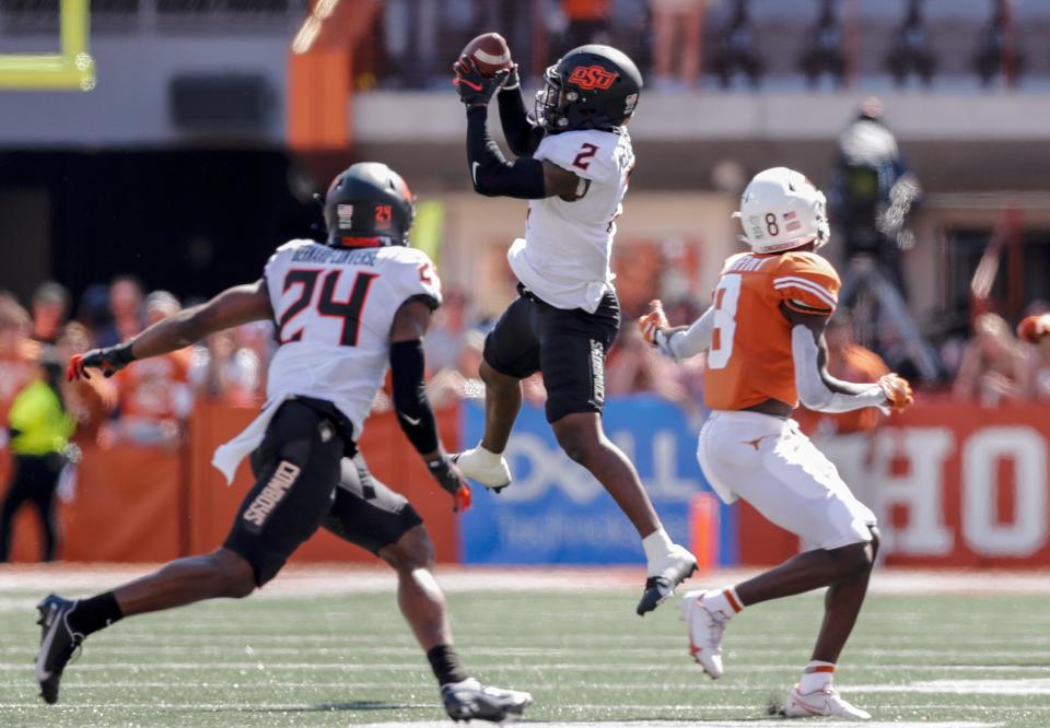 OSU's Tanner McCalister (2) intercepts a pass intended for UT's Xavier Worthy (8) during the fourth quarter of a 32-24 win on Oct. 16 in Austin, Texas.