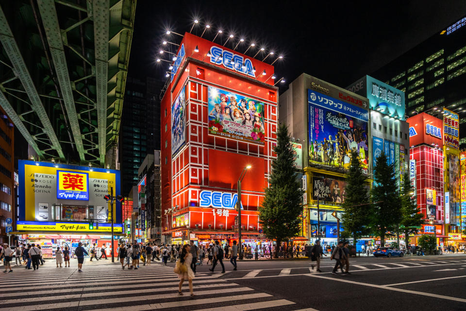 Tokyo, Japan, August 13, 2019 â€“ Scenic crosswalk in Akihabara district at night, with many electronics shops lined along the street