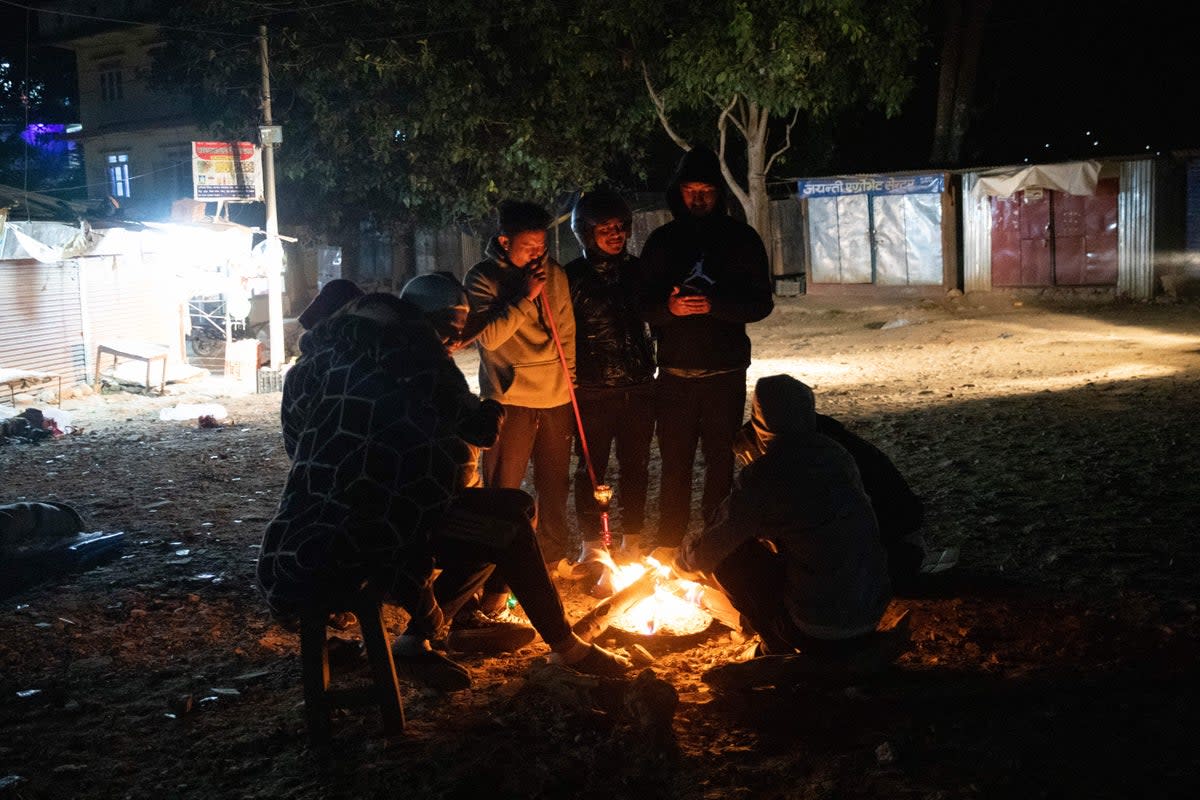 Residents gather around a fire in Jajarkot district after a 5.6-magnitude earthquake (AFP via Getty Images)