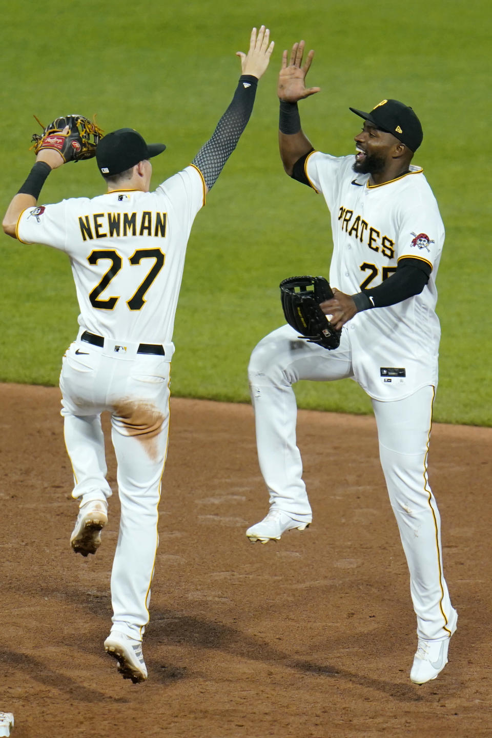 Pittsburgh Pirates' Kevin Newman, left, celebrates with Gregory Polanco, right, after getting the final out of a baseball game against the Chicago White Sox in Pittsburgh, Tuesday, June 22, 2021. (AP Photo/Gene J. Puskar)