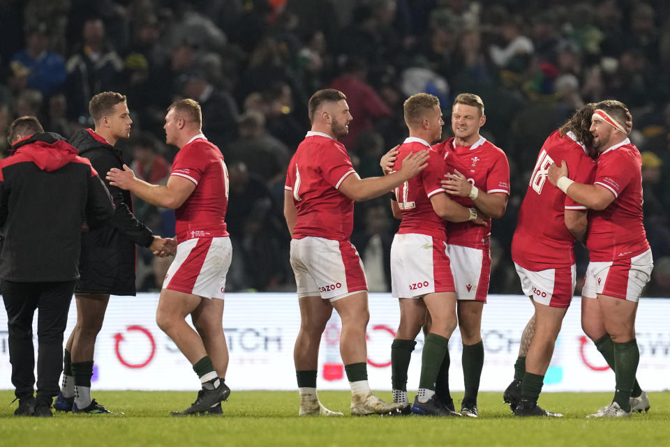 Wales' captain Dan Biggar, third from right, celebrates with teammates at end of the Rugby Championship test between South Africa and Wales at at Free State Stadium in Bloemfontein, South Africa, Saturday, July 9, 2022. (AP Photo/Themba Hadebe)