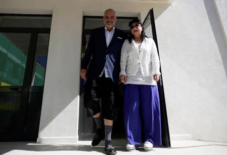 Albania's Prime Minister Edi Rama and his wife Linda Rama leave the polling station near Tirana