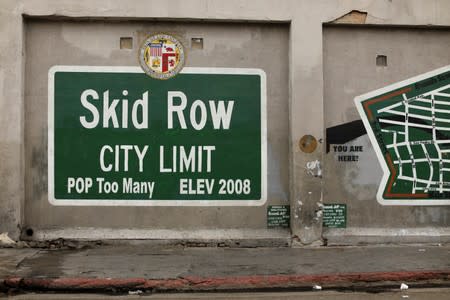 A sign painted on the side of a building marks the skid row area of downtown Los Angeles