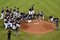 <p>Members of the Miami Marlins gather around the mound to honor fallen teammate starting pitcher Jose Fernandez prior to the game against the New York Mets at Marlins Park. Mandatory Credit: Jasen Vinlove-USA TODAY Sports </p>