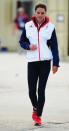 We love the contrast of Kate's over-sized sports jacket with skinny jeans. Her bright red tennis shoes really tie the outfit all together as she walks in the Olympic boat park on August 6.