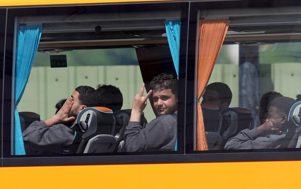 People believed to be migrants leaving by bus from the Border Force compound in Dover, Kent, following small boat crossings of the Channel